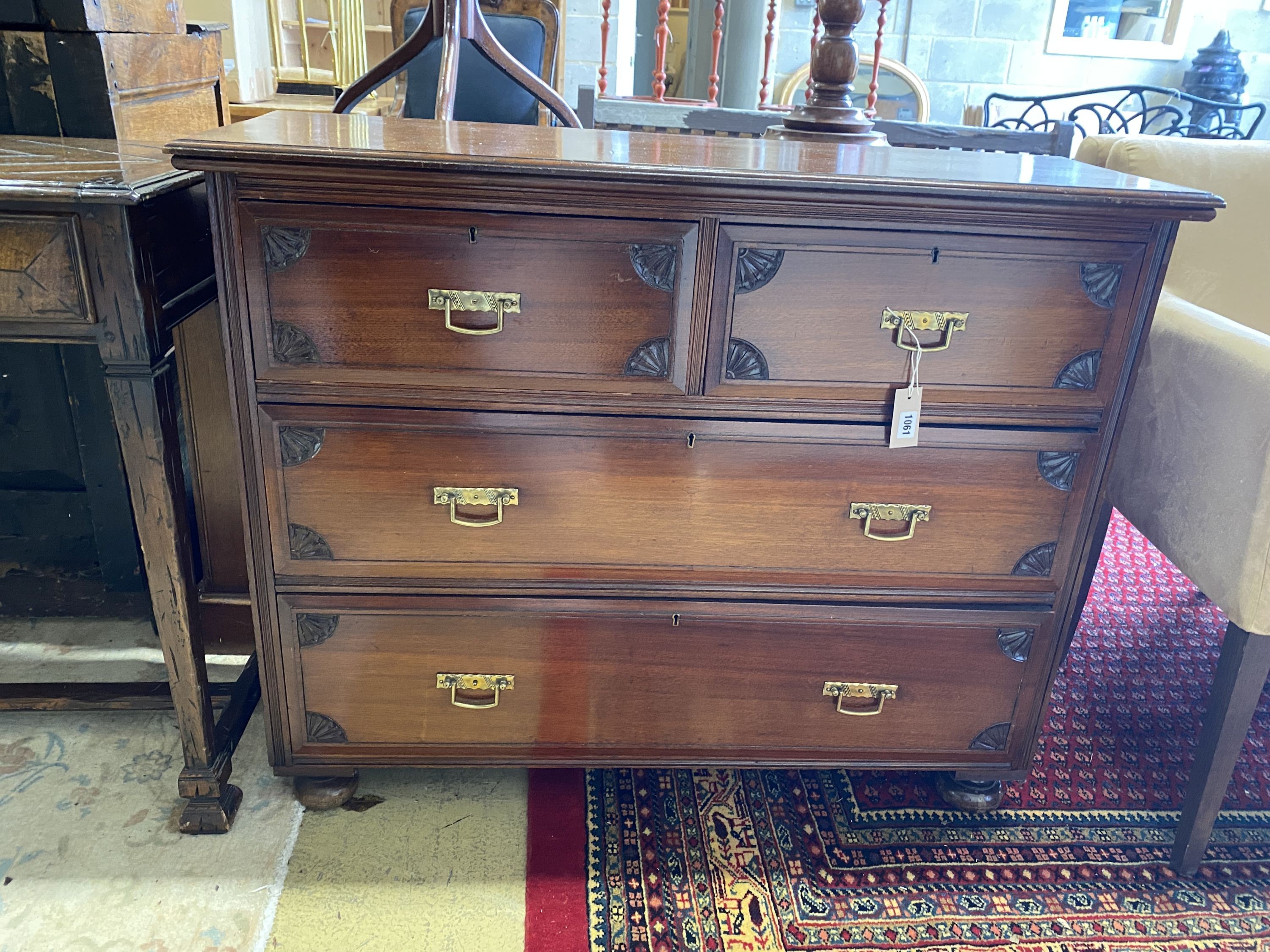 An Edwardian walnut chest of drawers, stamped Maple & Co., width 107cm, depth 36cm, height 86cm